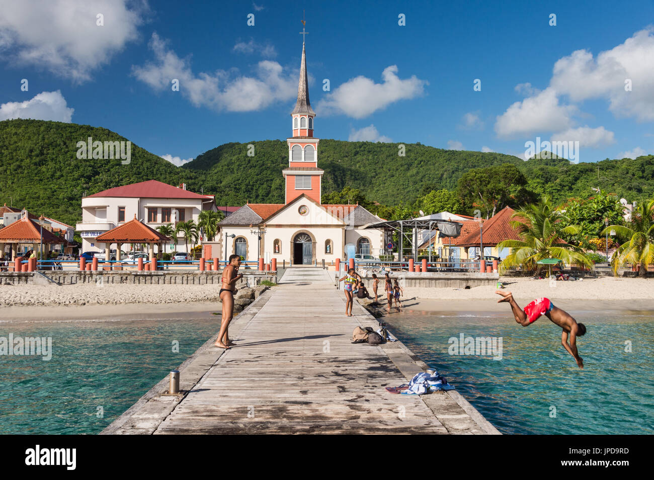 Petite Anse d'Arlet village, with Saint Henri Church and pontoon, in Martinique Stock Photo
