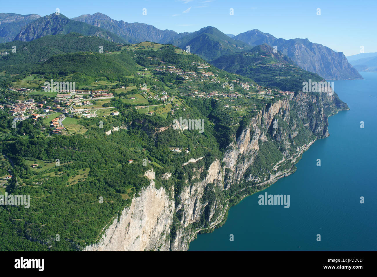 AERIAL VIEW. Picturesque village overlooking Lake Garda from its elevated terrace. Tremosine Sul Garda, Province of Brescia, Lombardy, Italy. Stock Photo