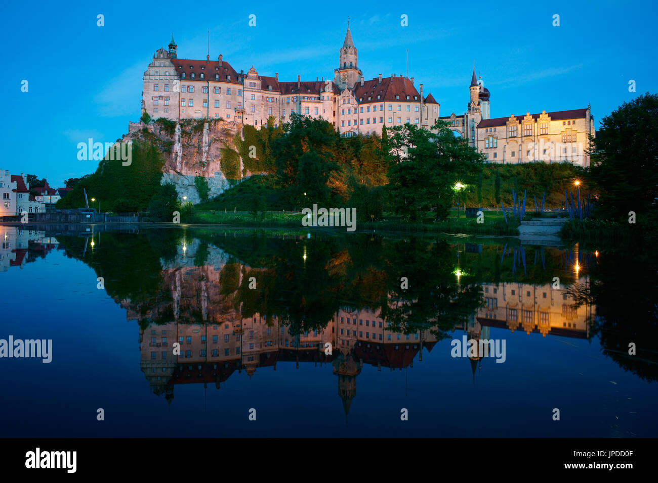 Sigmaringen Castle at twilight with its reflection on the Danube River. Baden-Wurttemberg, Germany. Stock Photo