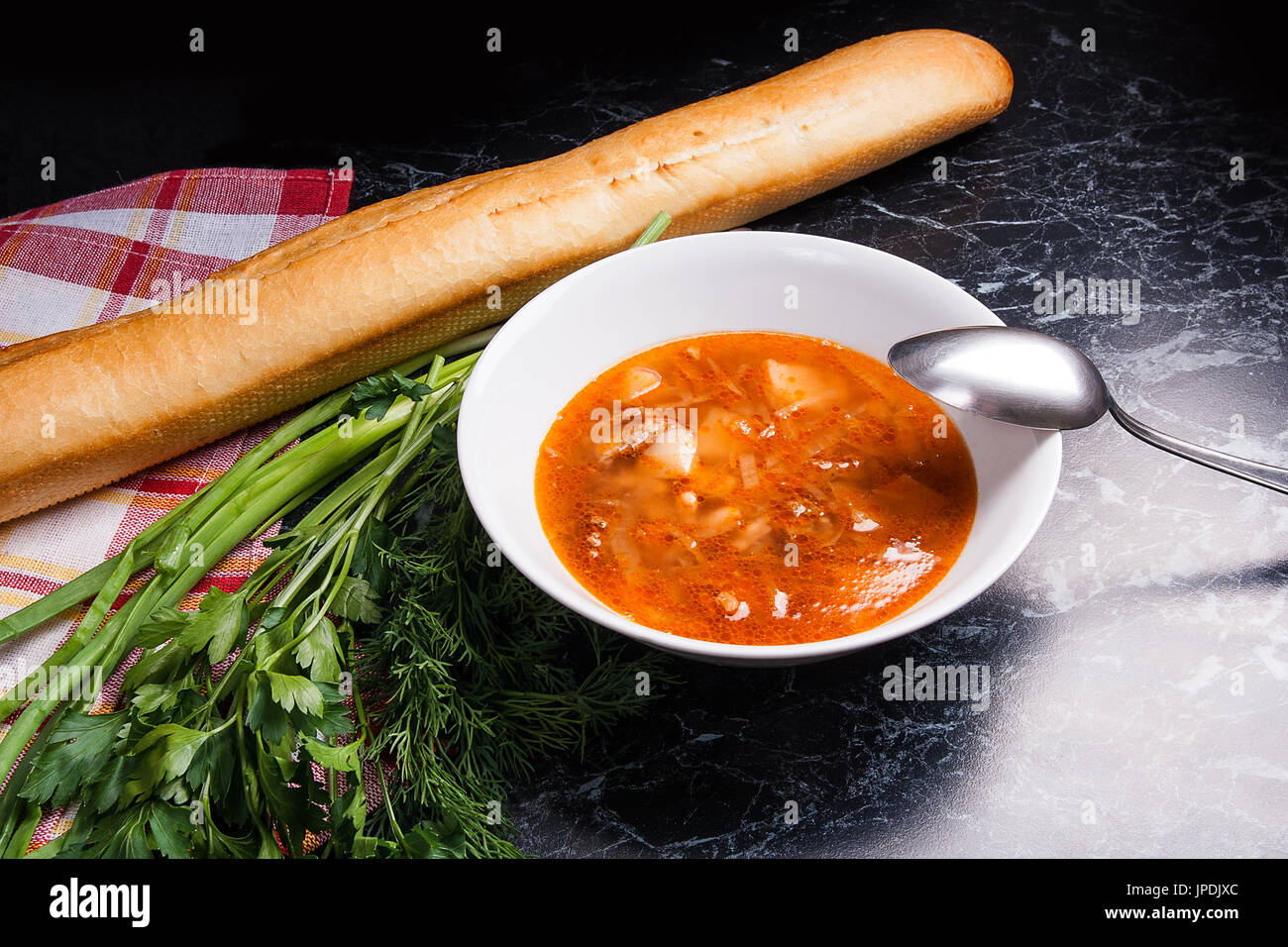 Vegetables and meat in red beetroot soup or borsch in white plate