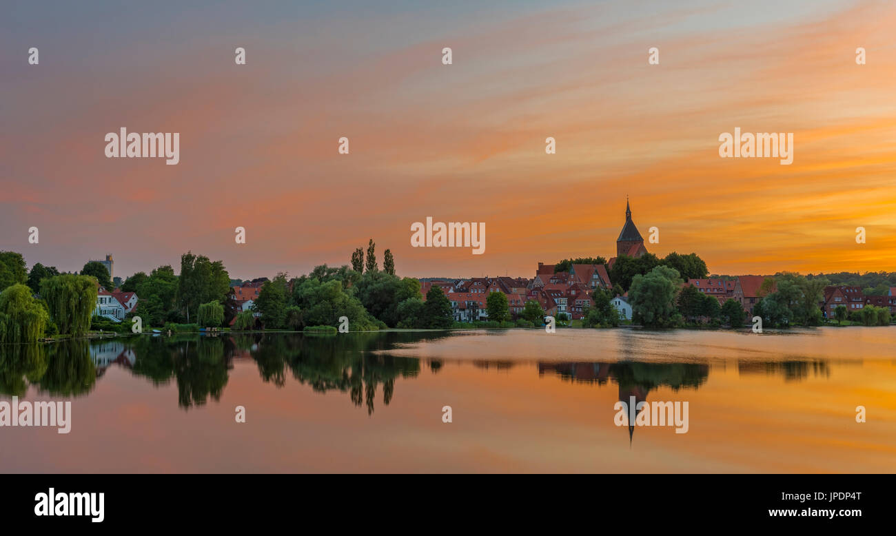 Cityscape with St. Nicholas' Church and lake Schulsee at sunset, Mölln, Schleswig-Holstein, Germany Stock Photo