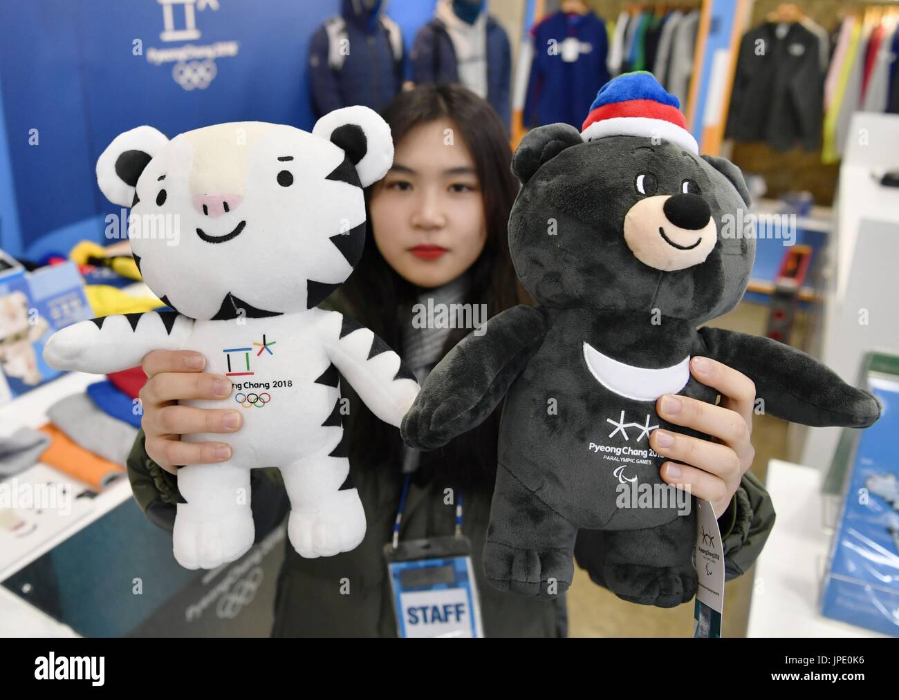 A woman shows dolls of Soohorang (L) and Bandabi, the official mascots ...