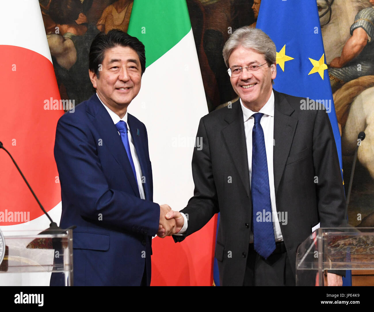 Japanese Prime Minister Shinzo Abe (L) shakes hands with his Italian ...