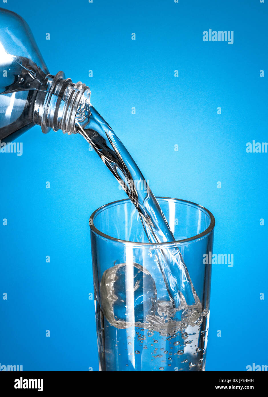 Pouring water in transparent crystal glass hires stock photography and