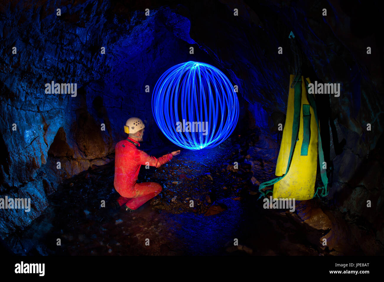 7 Fontane cave, Liguria, Italy. A caver is exploring a new cave. Orb of light underground Stock Photo