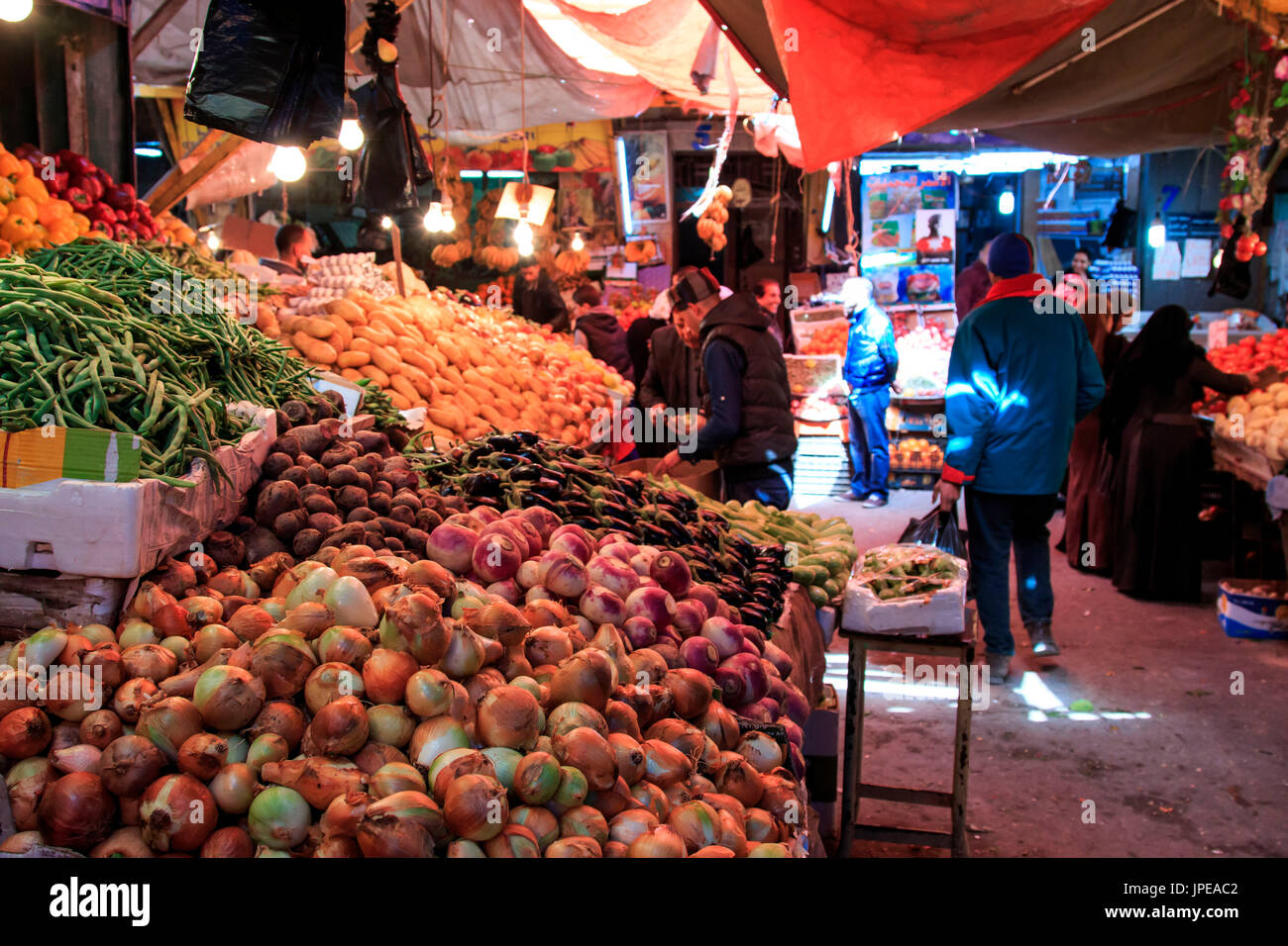 People and tourists walking in the vegetables market in the downtown Amman in Jordan Stock Photo