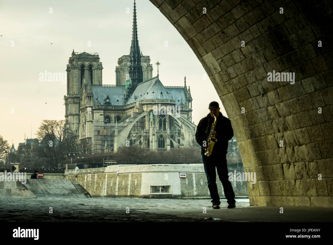 Musician in Paris under a bridge along the river Seine, Paris, France Stock Photo