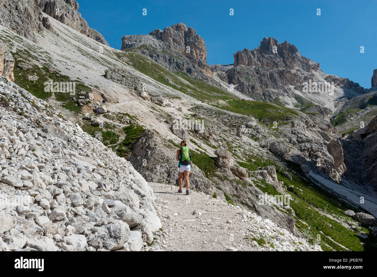 Italy, Trentino Alto Adige, Val di Fassa, Hiker on his way to the Principe Pass along the trial n.584 from the Vajolet refuge Stock Photo