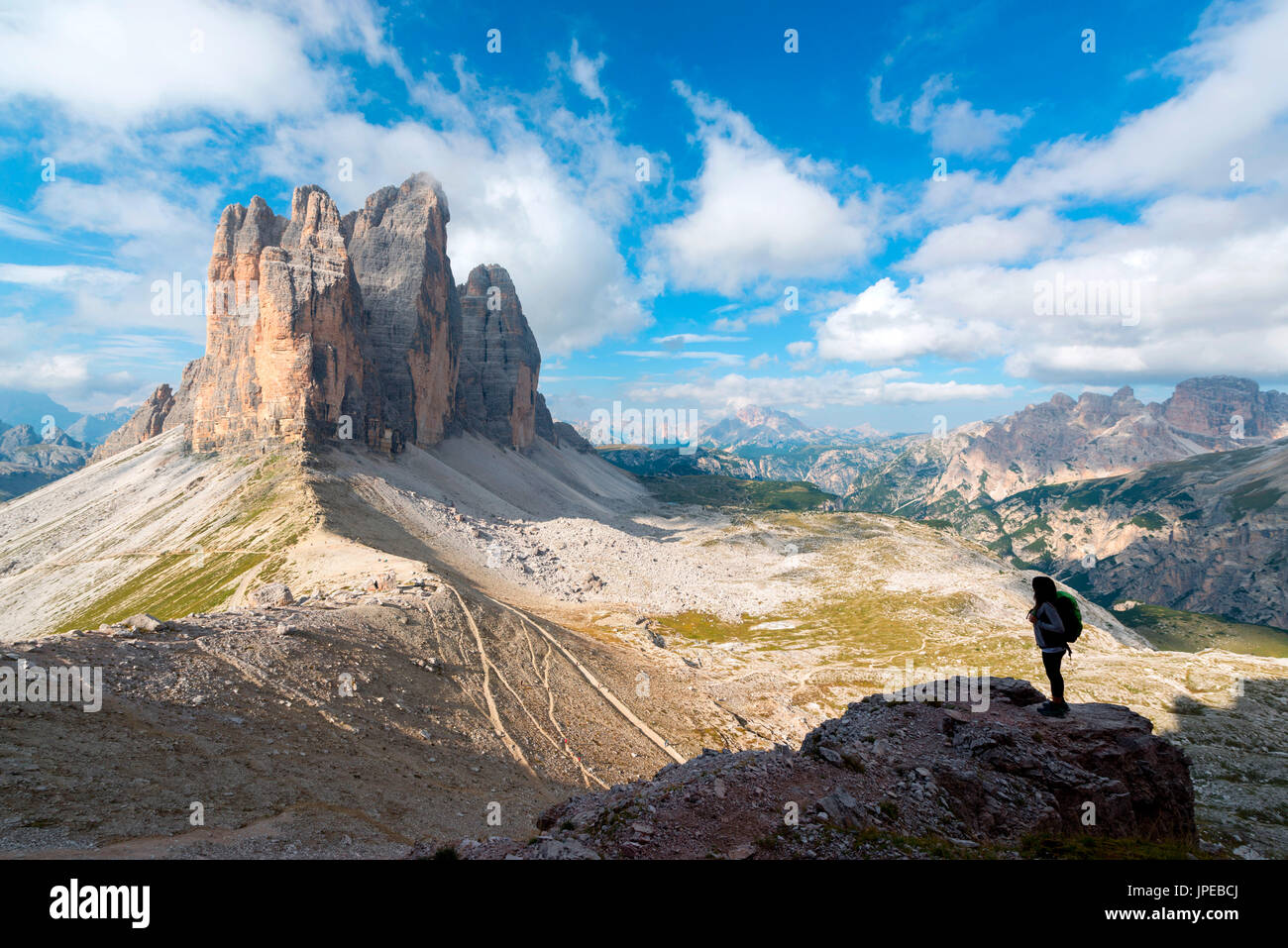 Europe, Italy, Dolomites, Veneto, Belluno. Woman hiker admire Tre Cime di Lavaredo from Trenches of the First World War on Mount Paterno Stock Photo
