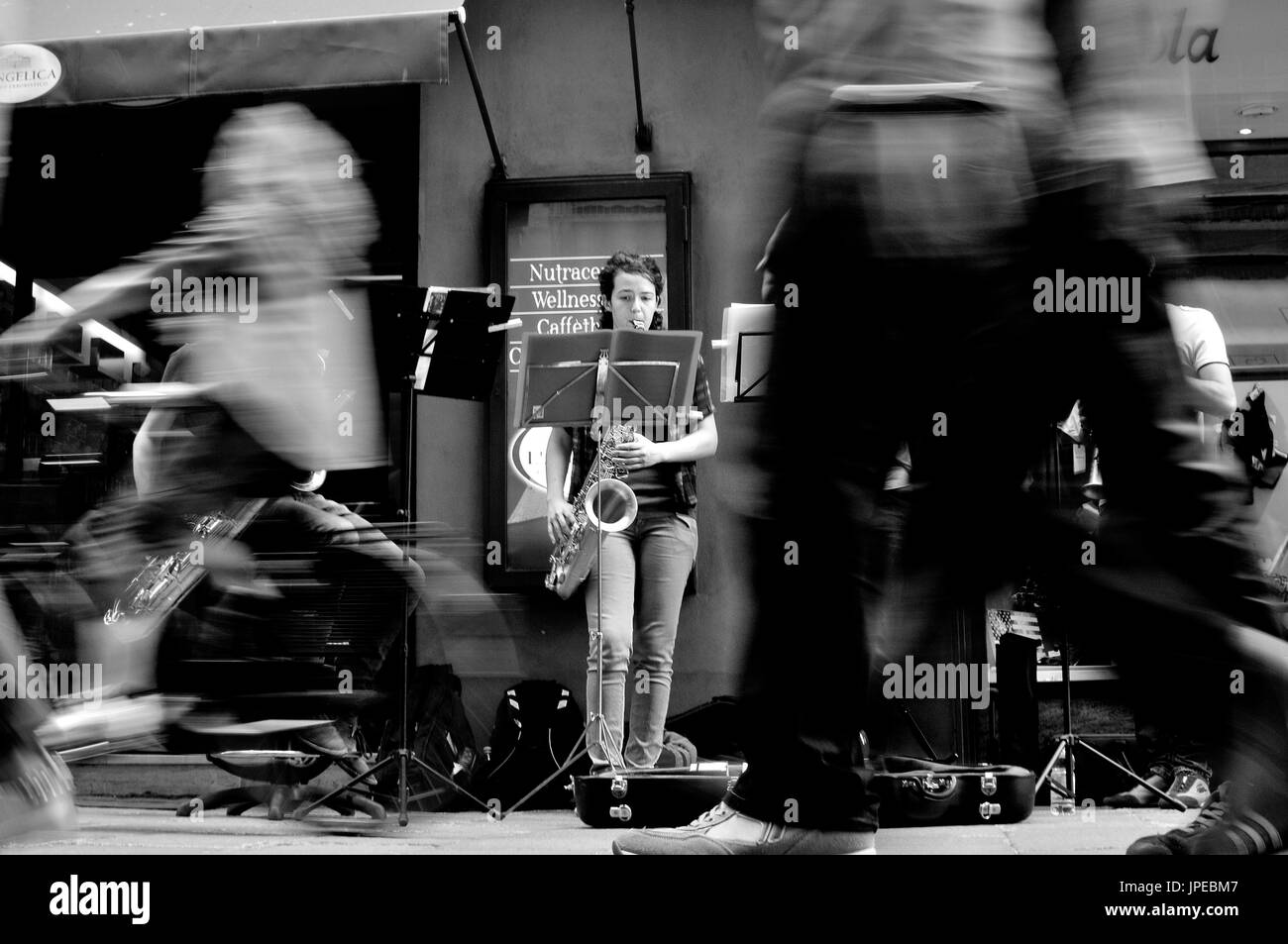 Bologna street photography. Musicians perform on the street in front of public on the move. Stock Photo