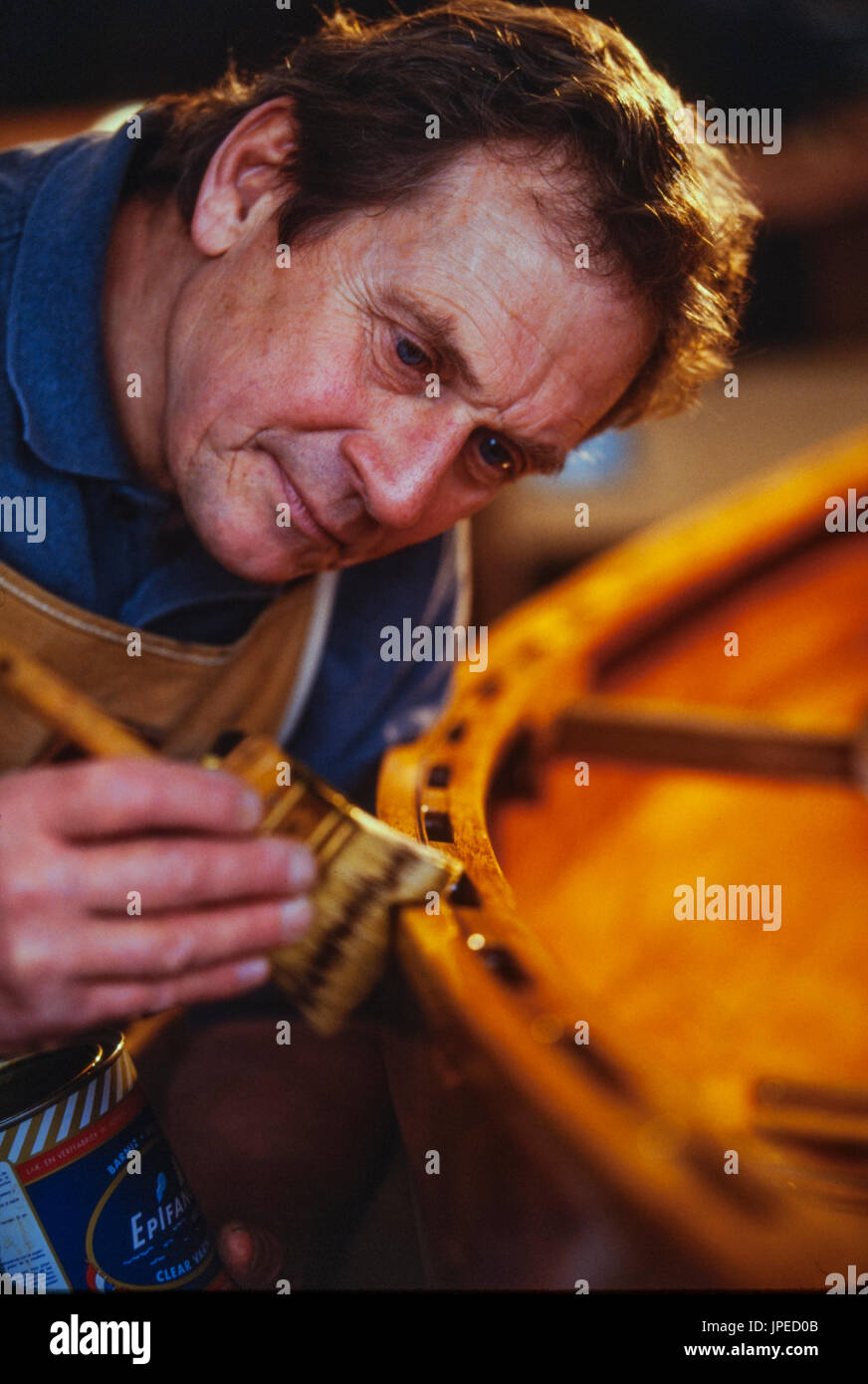 Master wooden boat builder Ted Schleisman of Ashland, Oregon works in his small shop on a mountainside. Stock Photo