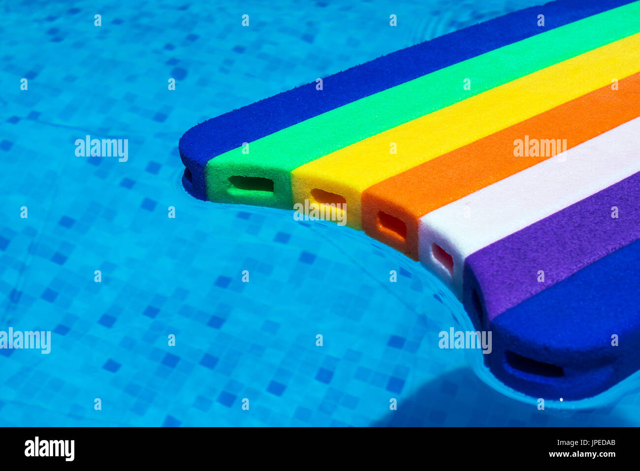 Rainbow pattern styrofoam swimming board or baseboard floating in