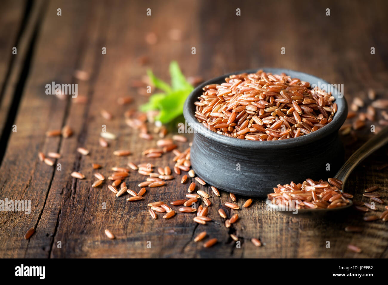 Rustic Red Rice Red rice an a small ceramic bowl against dark rustic wooden background ...