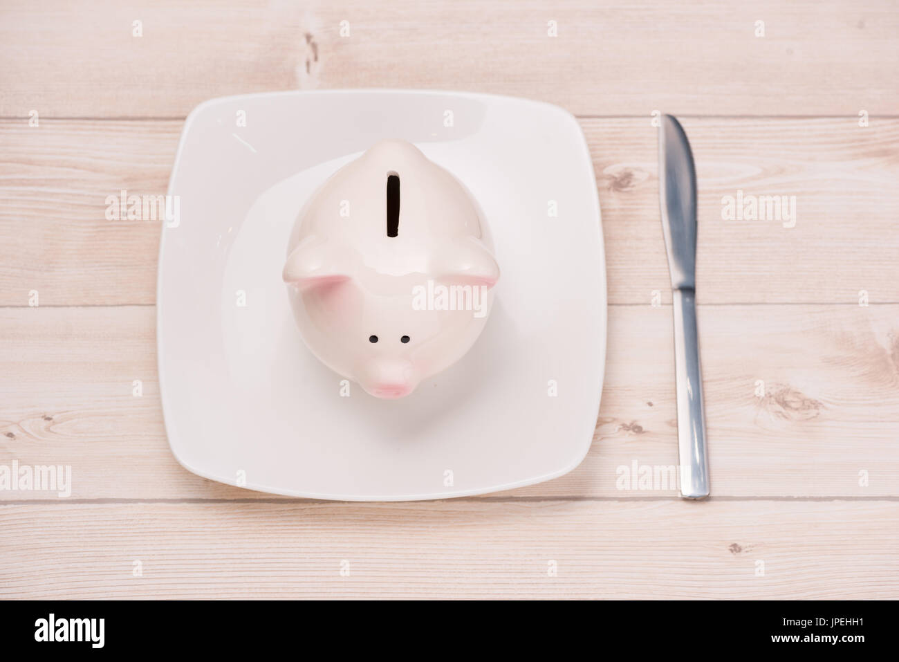 A pink piggy bank on dish. Financial concept. Stock Photo