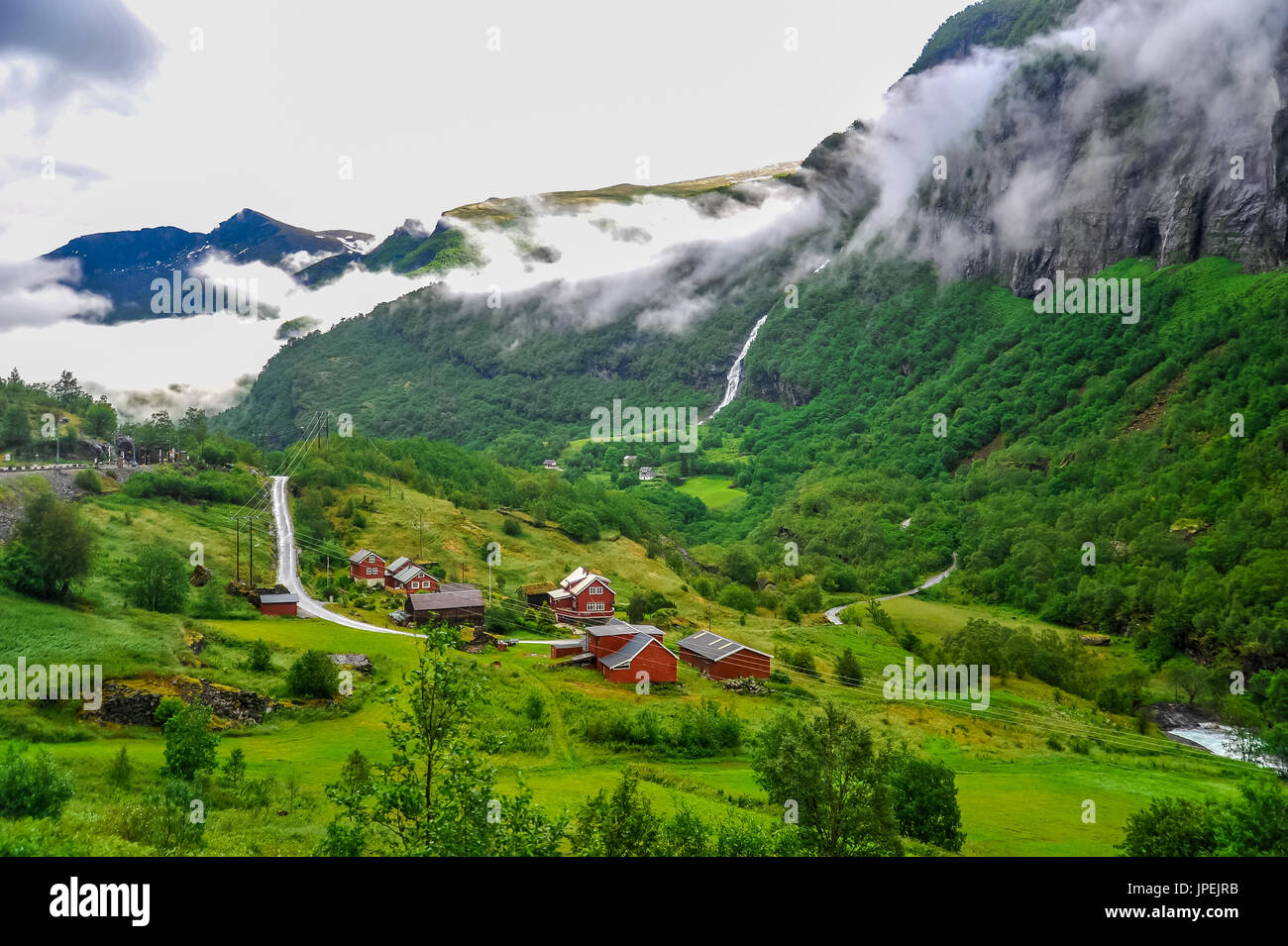 Beautiful Norway landscape and scenery view of village surrounded by green hills and mountain in a cloudy day Stock Photo