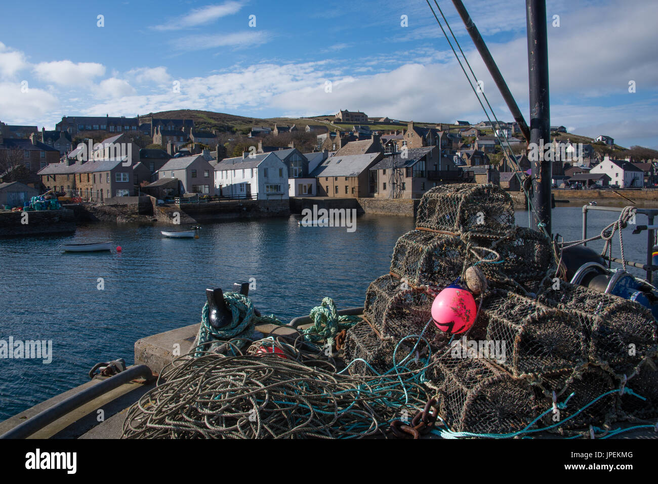 The West pier in Stromness harbour is littered with fihing equipment - nets, fish crates, old rope and other paraphernalia Stock Photo