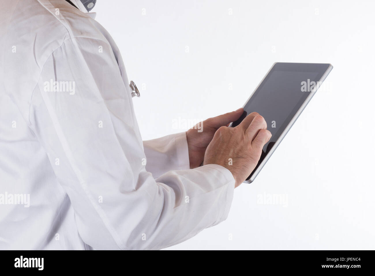 Doctor in a lab coat using a tablet computer navigating the blank black touchscreen with his finger in a close up view on white Stock Photo