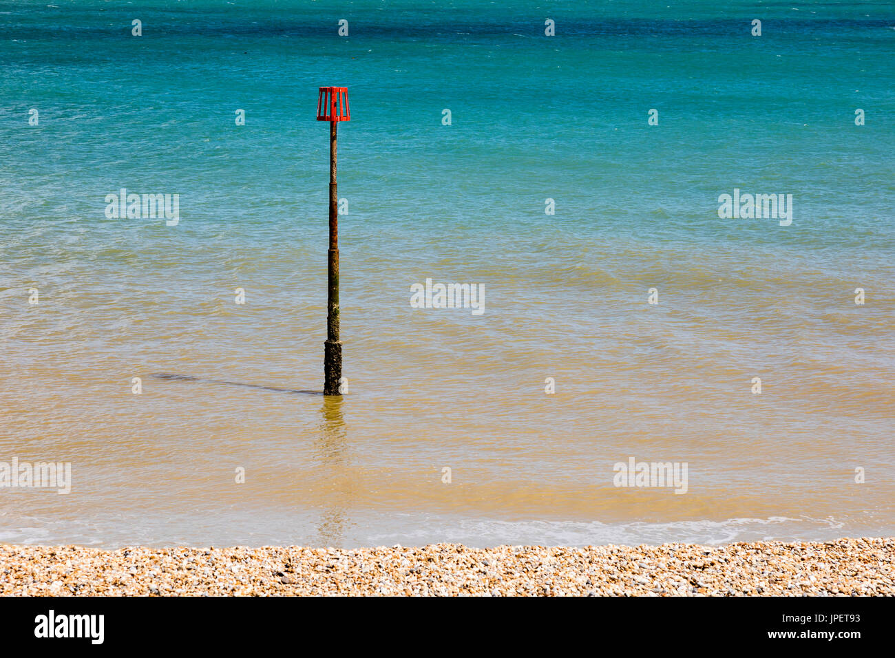 A navigation mark on the seafront at Deal, Kent, Uk against the Azure blue English Channel. Stock Photo