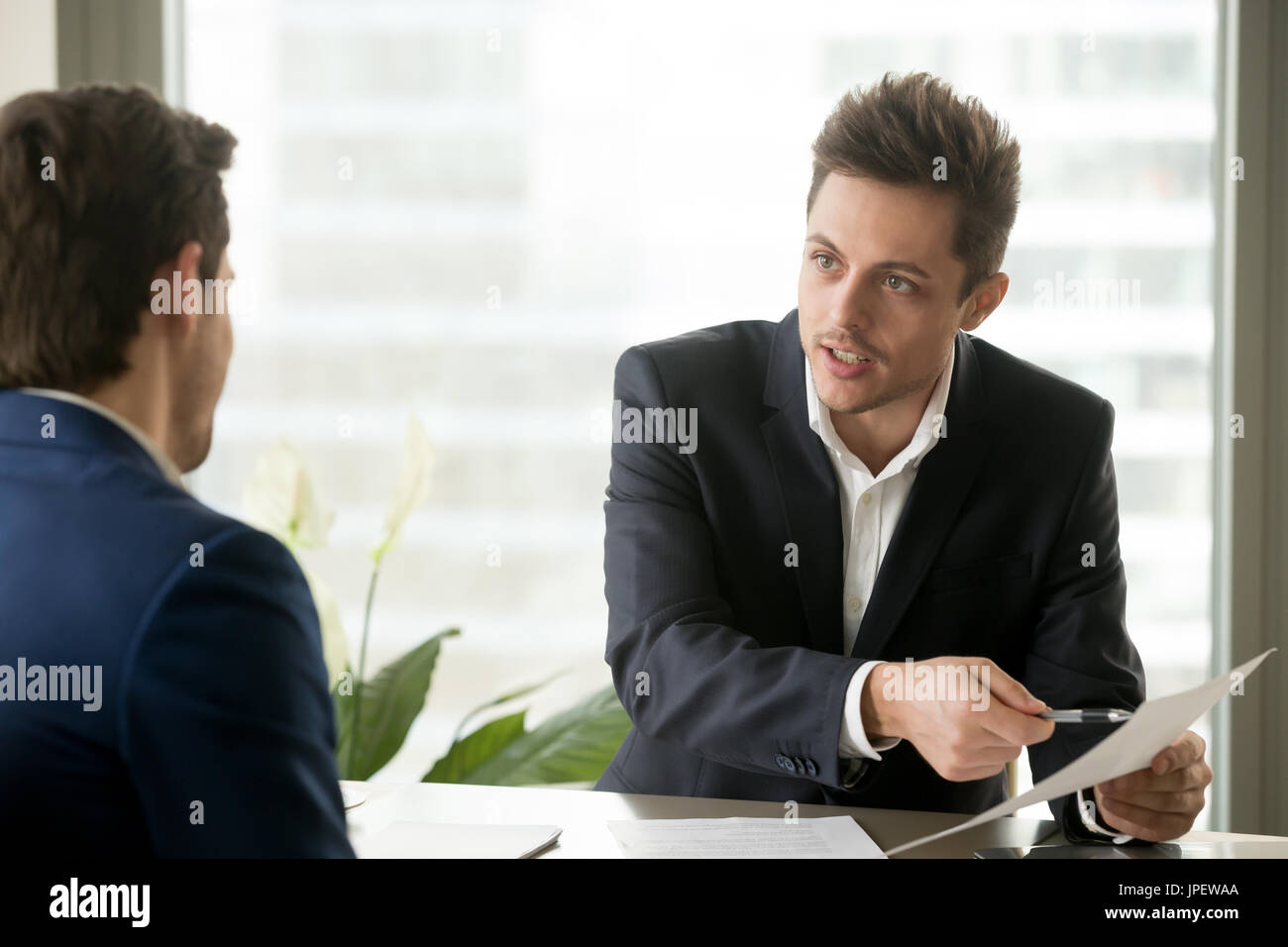 Financial adviser consulting businessman, discussing contractual Stock Photo