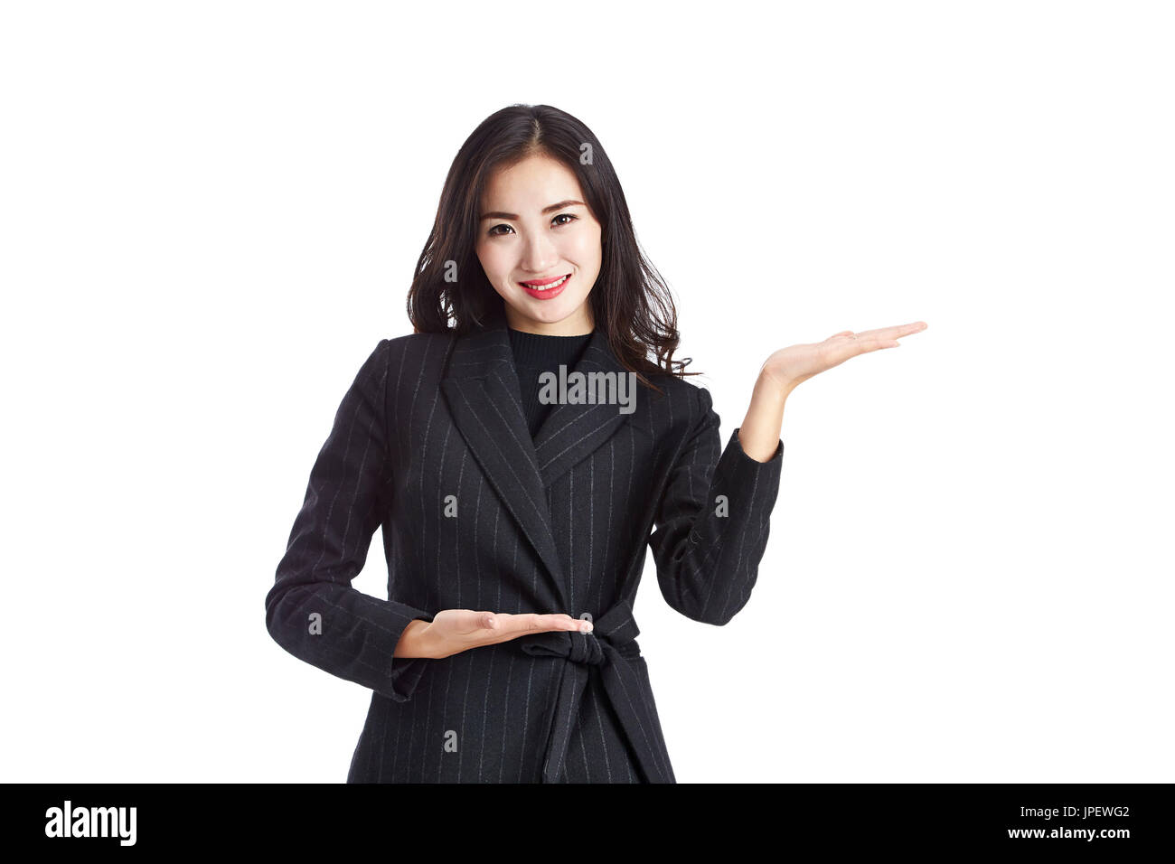 young and beautiful asian business woman in formal wear showing or presenting something to customer, isolated on white background. Stock Photo