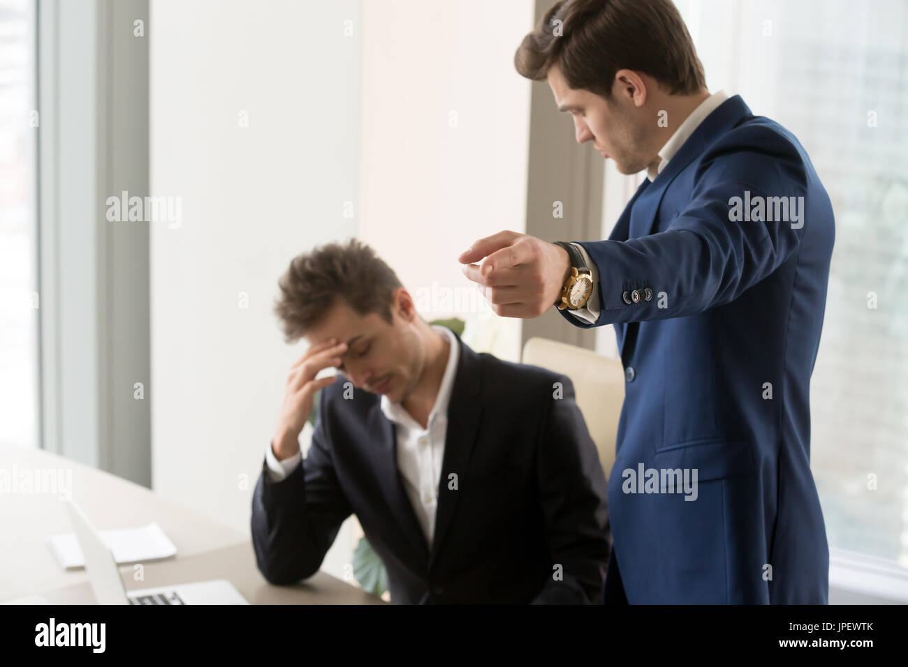 Angry boss dismissing frustrated upset subordinate, getting fire Stock Photo