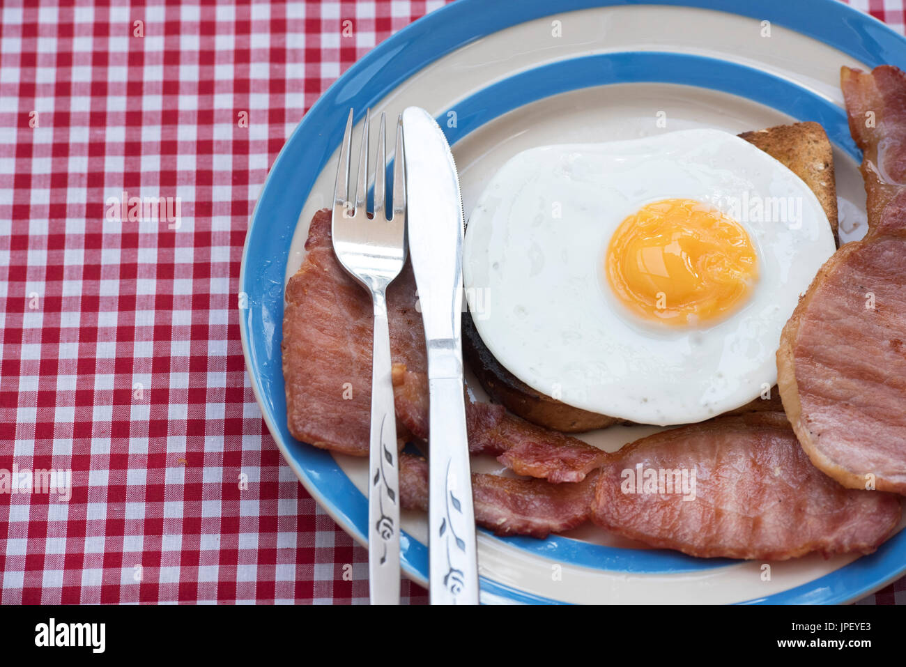 Fried egg and bacon on toast. UK Stock Photo