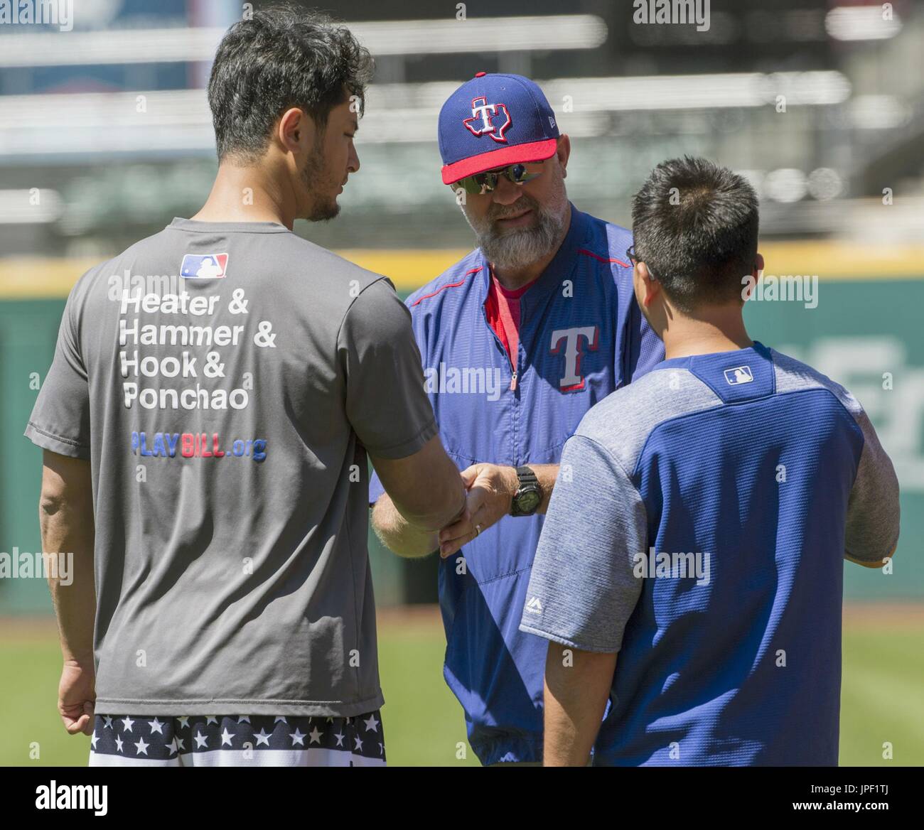 Texas Rangers pitching coach Doug Brocail (C) gives an arm massage to
