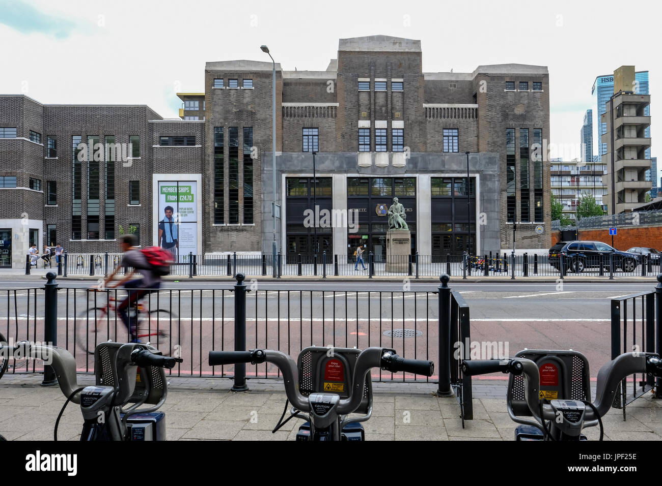 Poplar, London, UK - July 16, 2017:  Poplar Baths, regenerated looking from Chrisp Street with Boris bikes in the foreground. Stock Photo