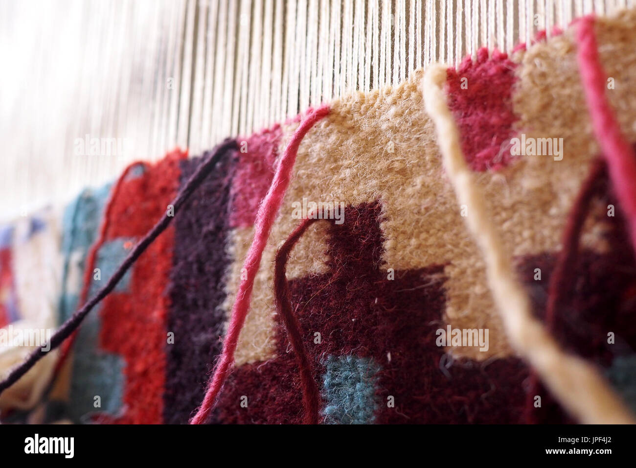 Wool on a hand loom for making carpets Stock Photo Alamy