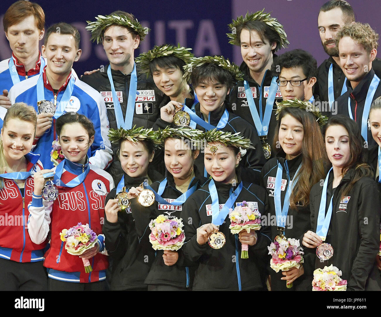 Figure skaters from Japan (C), Russia (L) and the United States pose on