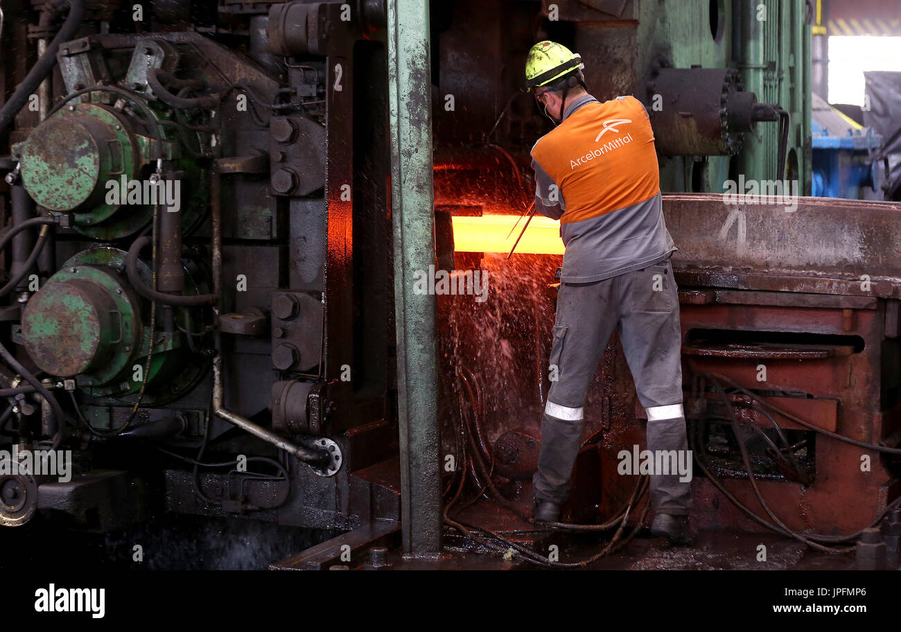 A rolling mill in a metallurgical plant of the ArcelorMittal Ostrava is seen during an extremely hot day in Ostrava, Czech Republic, on August 1, 2017. At the time of heat, workers working in ArcelorMittal Ostrava's hot factories are exposed to excessive working temperatures. In the rolling mill operation its hot stamped plates with a temperature of up to 1200 degrees of Celsius. Employees therefore have a more frequent break mode that they can spend in air-conditioned areas. The company also provides them with more beverages. (CTK Photo/Petr Sznapka) Stock Photo
