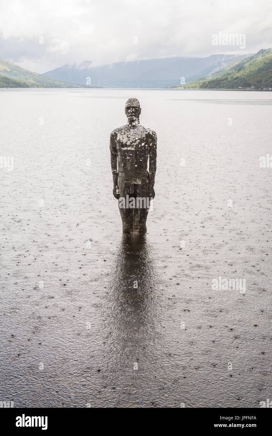 Loch Earn, St Fillans, Perth and Kinross, Scotland, UK. 1st Aug, 2017. UK weather - a looming figure titled 'Still', but locally known as Mirror Man endured a day of heavy showers with brief sunny intervals. The artwork by artist Rob Mullholland is made from mirrored tiles. Credit: Kay Roxby/Alamy Live News Stock Photo