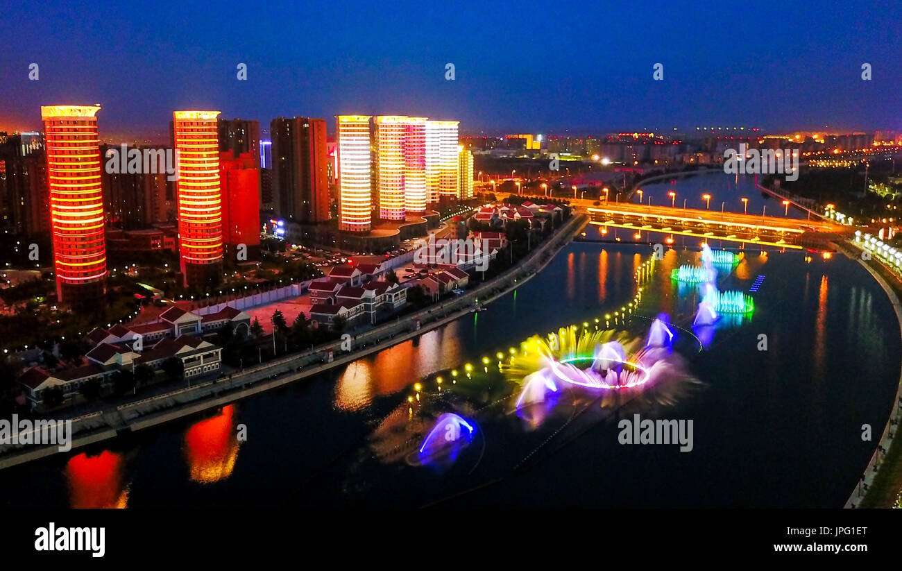 (170802) -- HOHHOT, Aug. 2, 2017 (Xinhua) -- Photo taken on July 31, 2017 shows the night scene of the Ruyi River in Hohhot, capital of north China's Inner Mongolia Autonomous Region. This group of photos taken by drones shows landmarks of the city, reflecting the development of the city in recent years. This year marks the 70th anniversary of the founding of the Inner Mongolia Autonomous Region. In local language, Hohhot means the 'Blue City'. It is the political, economic and cultural center of the region.  (Xinhua/Lian Zhen)(mcg)(zt) Stock Photo