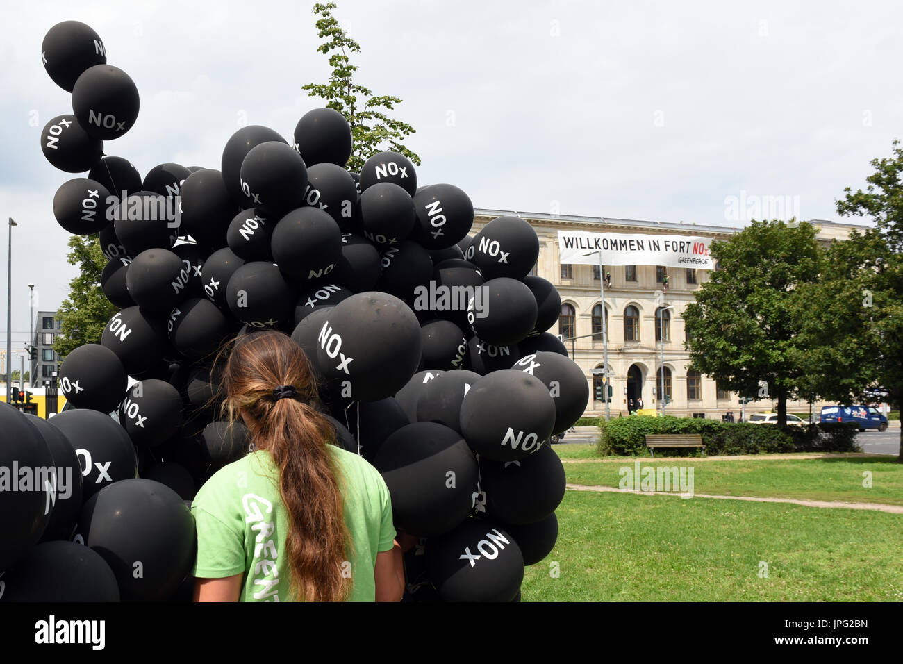 Berlin, Germany. 2nd Aug, 2017. Berlin. 2nd Aug, 2017. A Greenpeace activist protests in front of the Ministry of Transport after a summit on the reduction of diesel use on August 2, 2017 in Berlin. The abbreviation NOx on the balloons stands for nitrogen oxide, which is released in high concentration by some diesel motors. It can act as a respiratory poison. Credit: dpa picture alliance/Alamy Live News Stock Photo