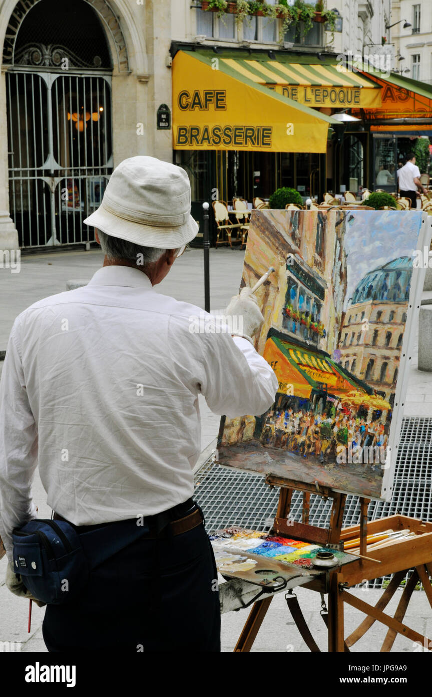 Artist painting a street scene in central Paris, France. Stock Photo