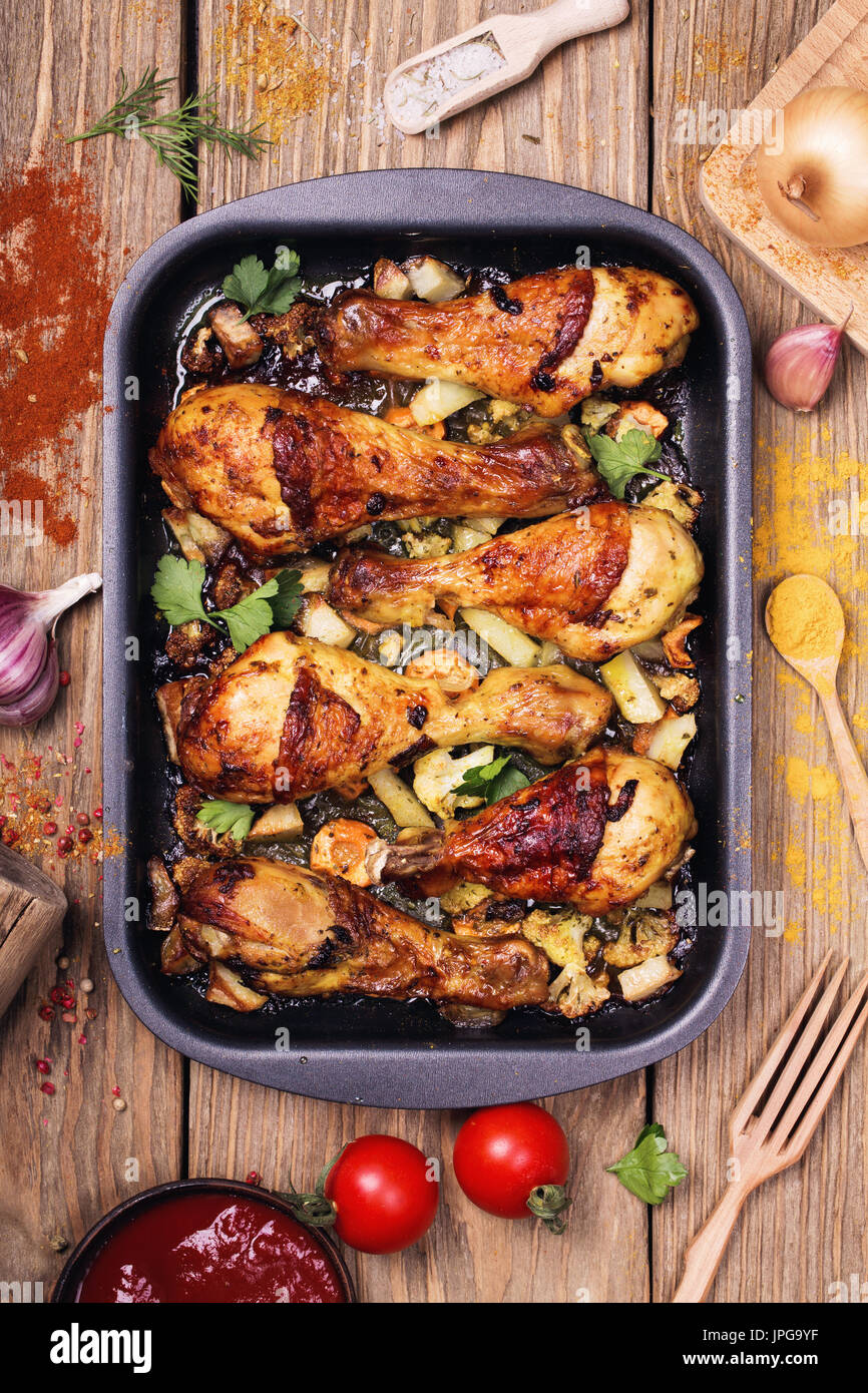 Hot and spicy chicken drumsticks on serving pan. Top view Stock Photo