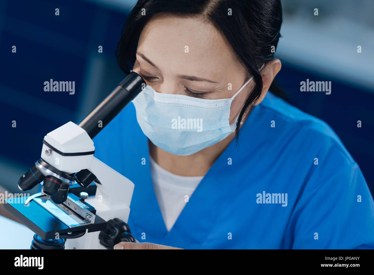 Serious skillful microbiologist using special equipment Stock Photo Alamy