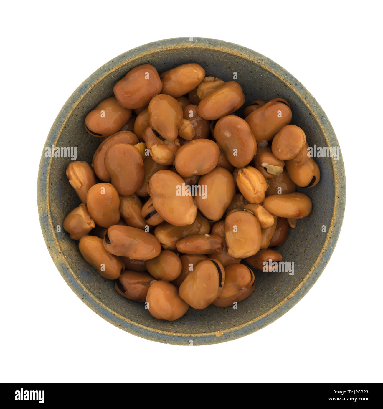 Top view of canned fava beans in an old stoneware bowl isolated on a
