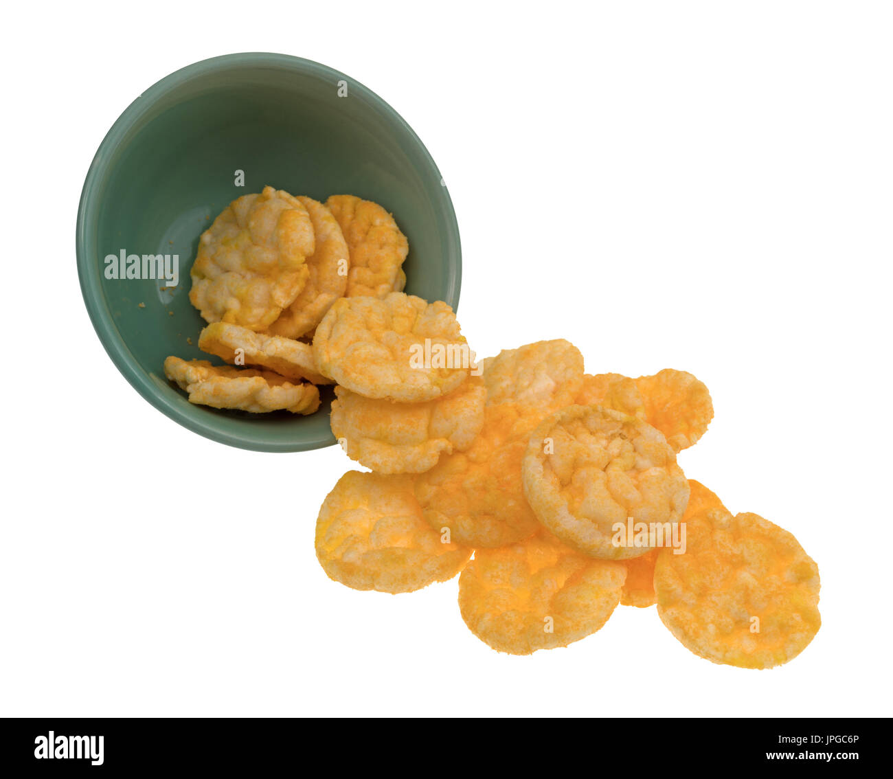 Cheddar cheese rice cakes spilling from a bowl isolated on a white