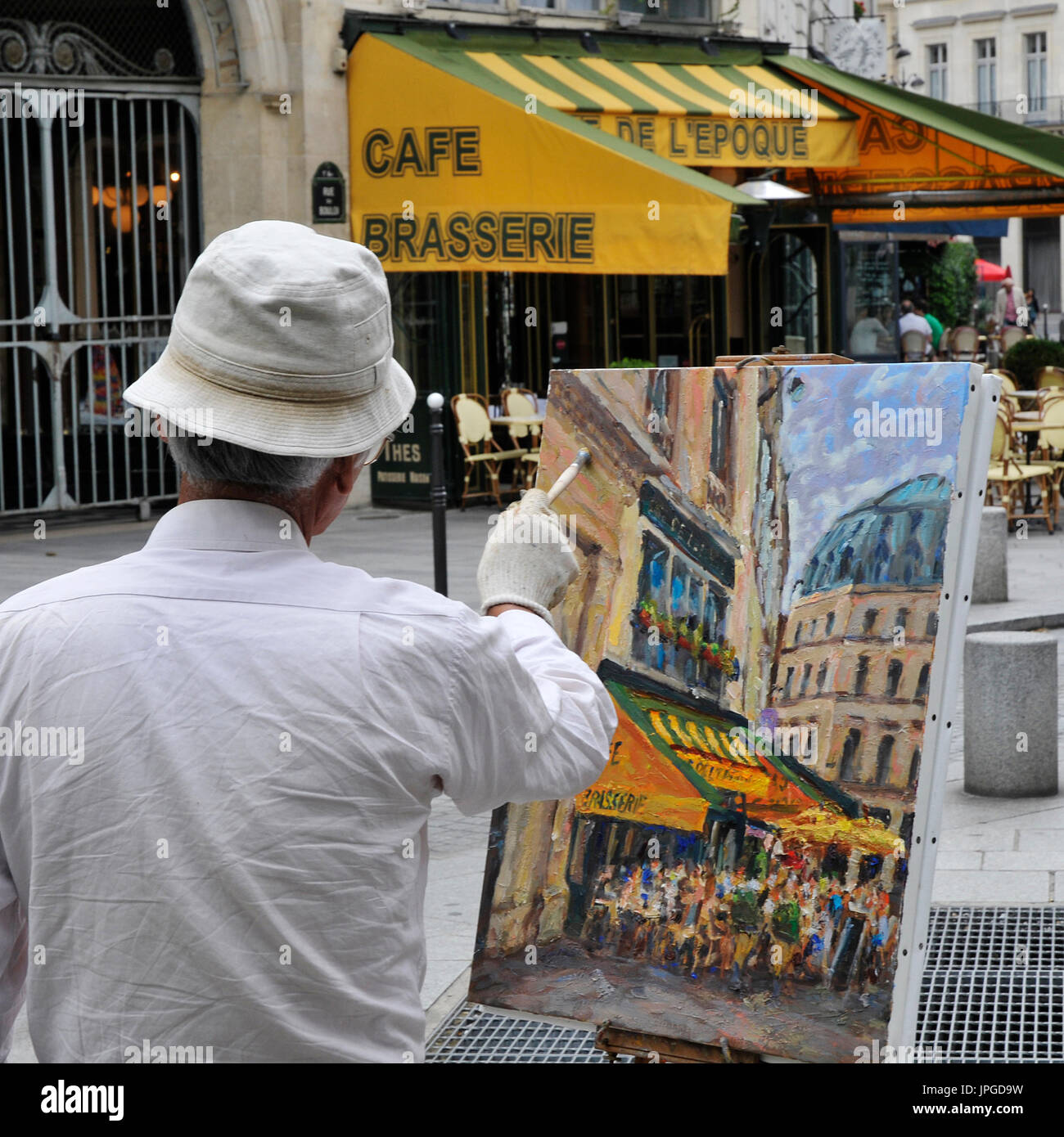 Artist painting a street scene in central Paris, France. Stock Photo