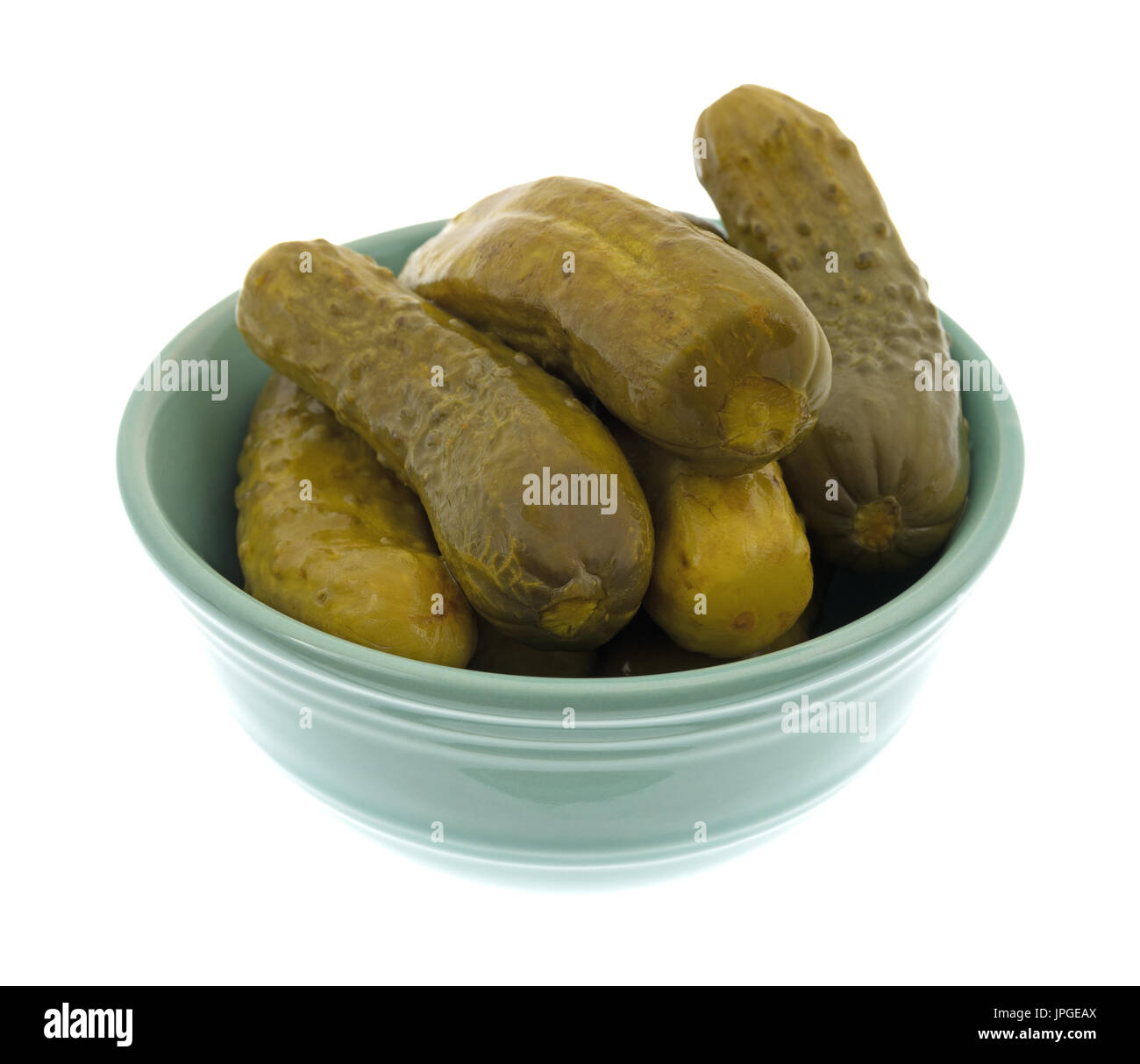 A bowl filled with kosher baby dill pickles isolated on a white
