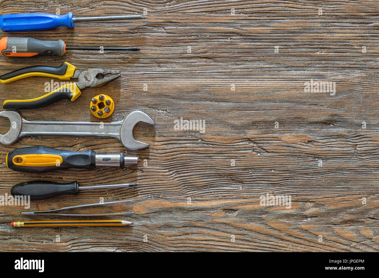 Tools on an old wooden background with copy space. Stock Photo