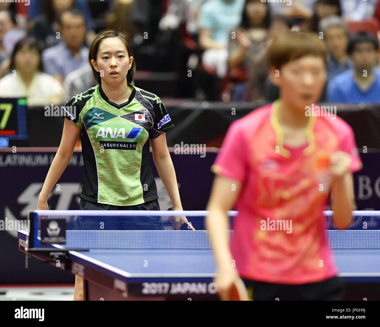 Kasumi Ishikawa of Japan reacts after losing a point to China's Wang