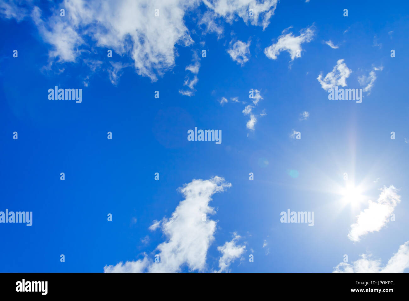 landscape with blue sky with white clouds and sun Stock Photo - Alamy