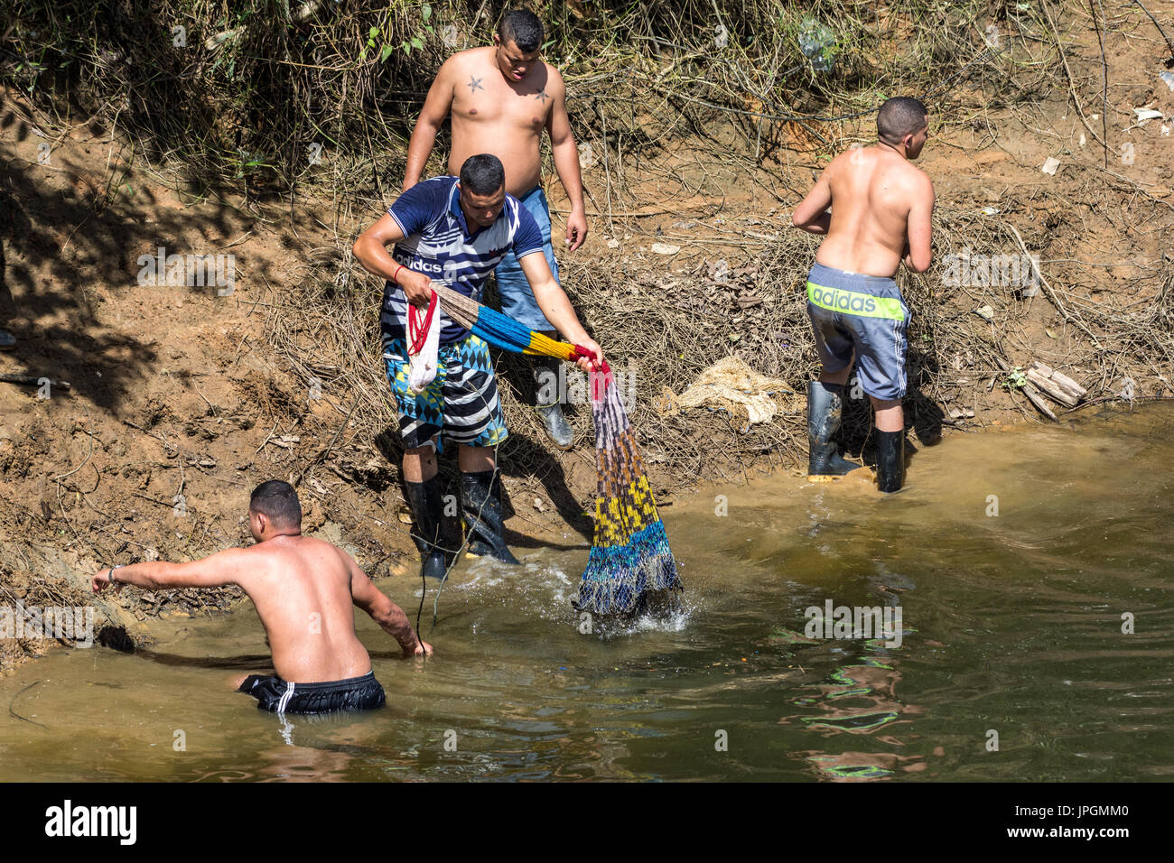 Local people fishing in a lake with a net. Colombia, South America. Stock Photo
