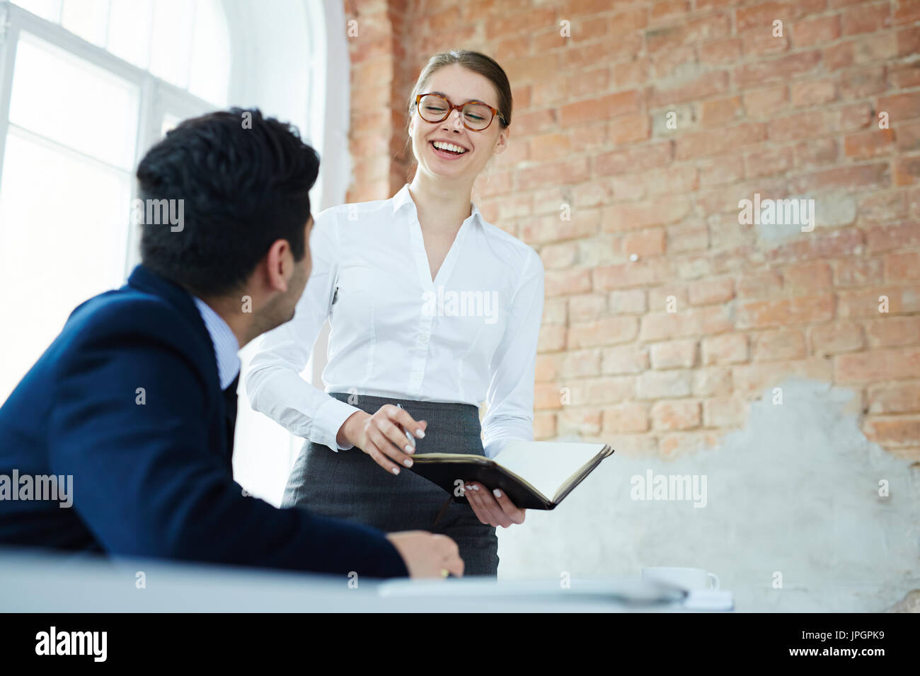 Successful managers discussing new ideas while preparing for business conference Stock Photo