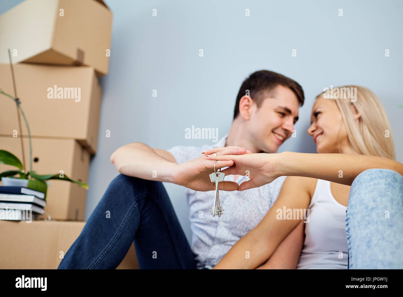 A couple with key in a new apartment for a housewarming. Stock Photo