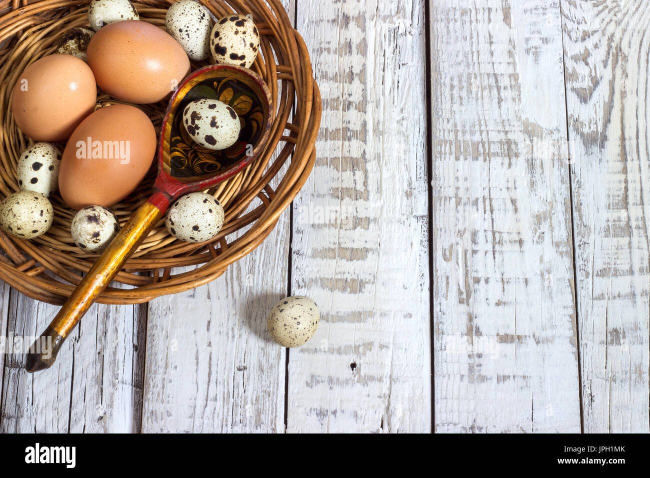 chicken and quail eggs on a white wooden background Stock Photo - Alamy
