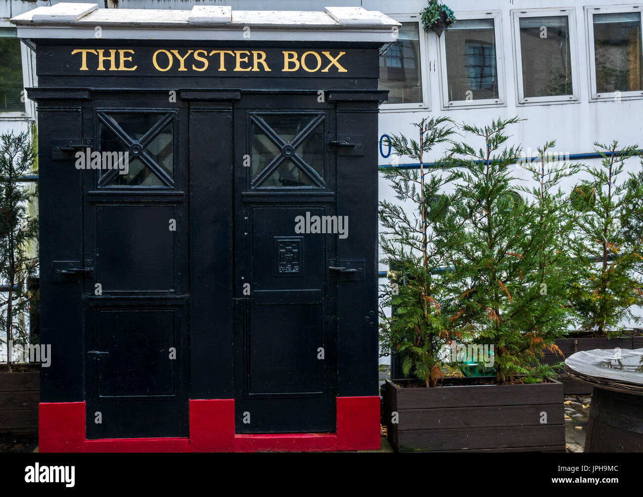 Old fashioned police telephone call box converted to food takeway stand called The Oyster Box, The Shore, Leith, Edinburgh, Scotland, UK Stock Photo