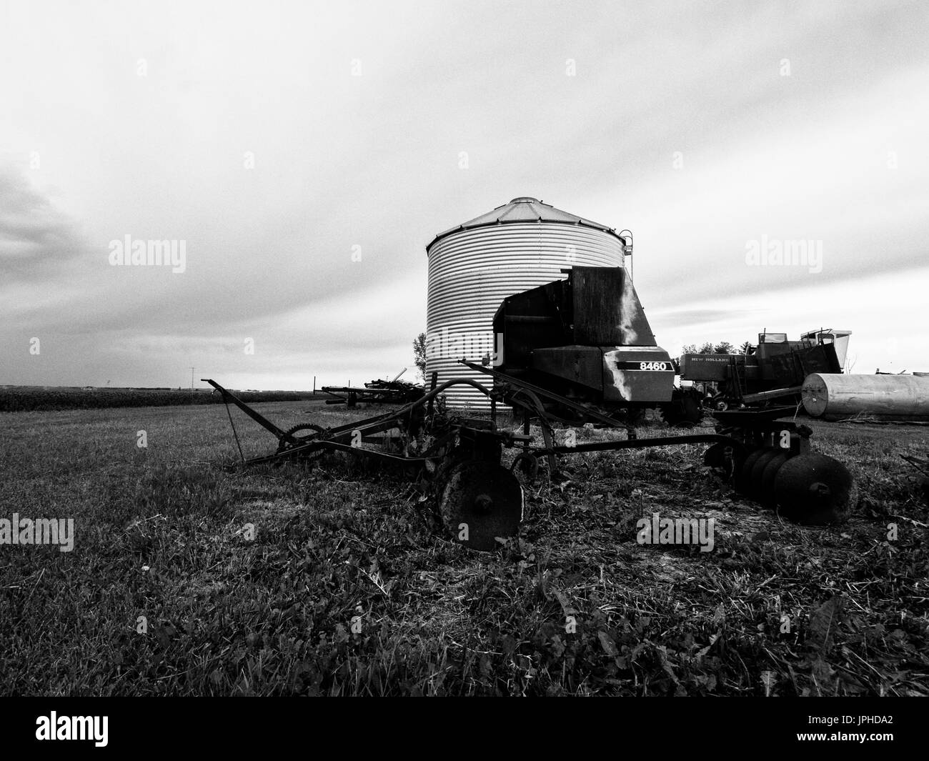 Black and white Old farm Equipment and grain barrels Stock Photo Alamy